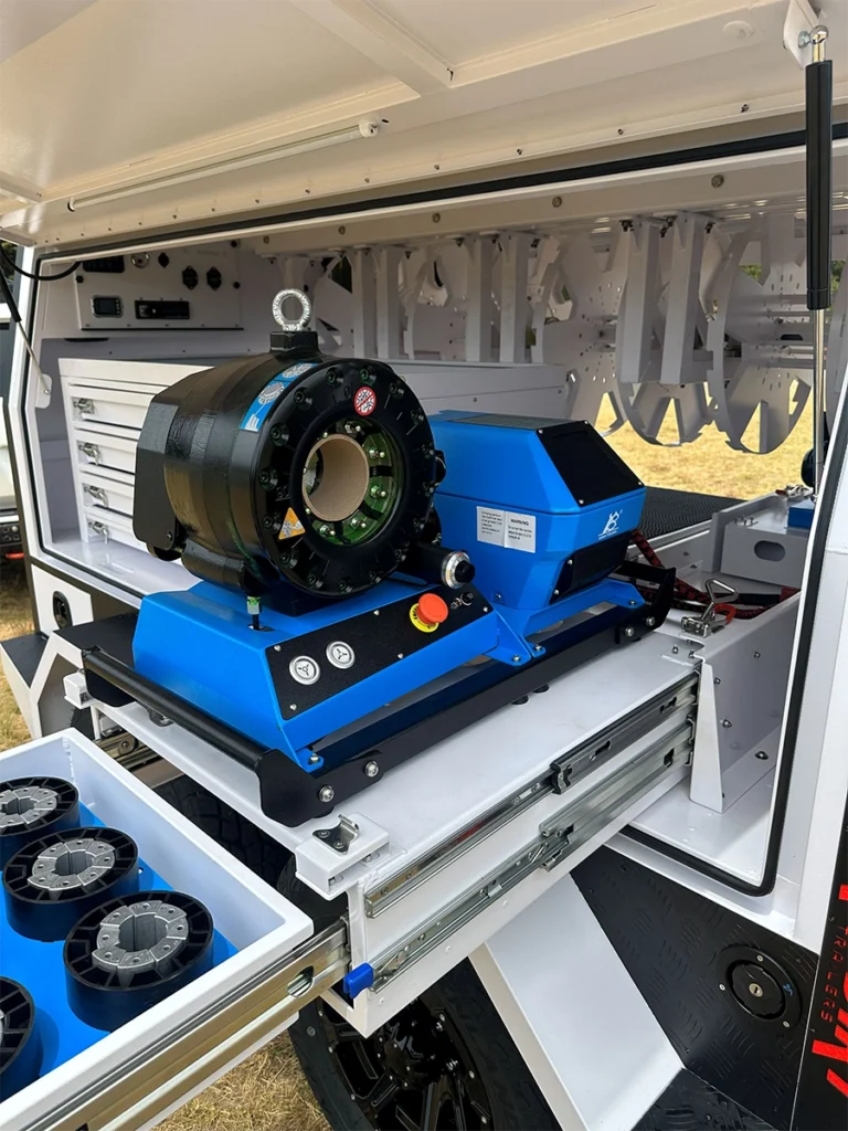 Hydraulic hose press machine installed inside the RedDirt hydraulic repair trailer for on-site hose crimping